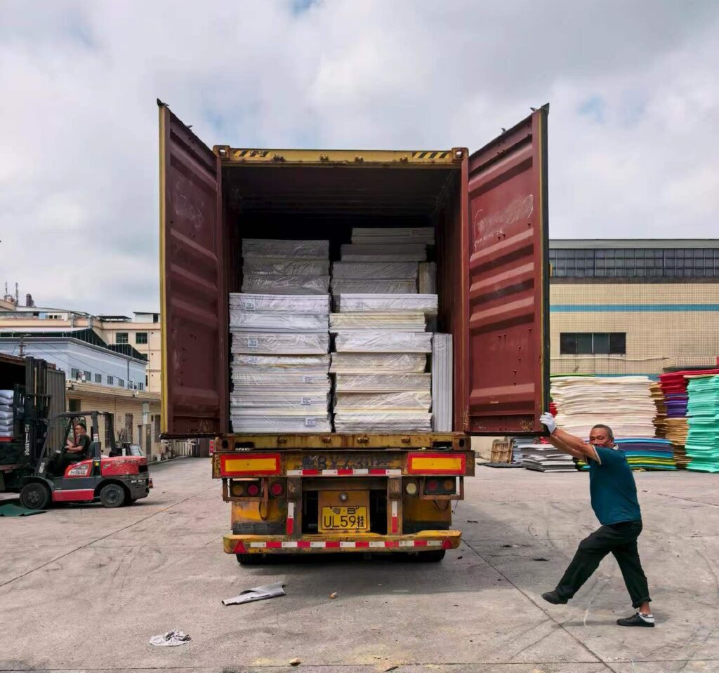 Loading a 40HQ container with white EVA foam sheets for a US client